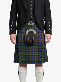 Person wearing a traditional Scottish kilt with a tartan pattern on a white background