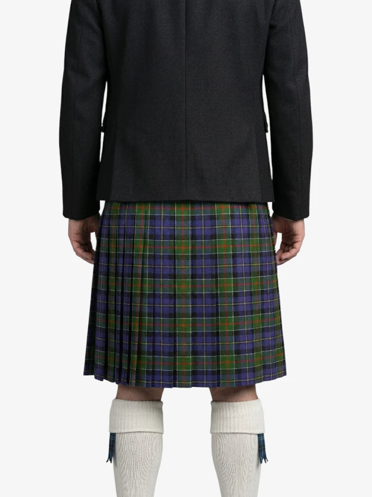 Person wearing a black jacket and plaid kilt on a white background