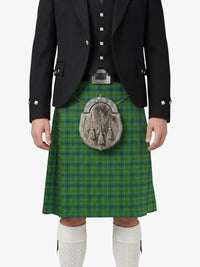 Person wearing a green plaid kilt with a black jacket and white knee-high socks on a white background