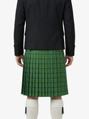 Person wearing a black jacket and green plaid kilt on a white background