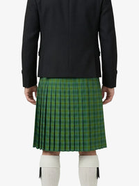 Person wearing a black jacket and green plaid kilt on a white background