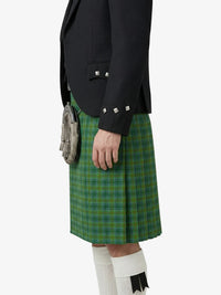 Person wearing a green plaid kilt with a black jacket on a white background