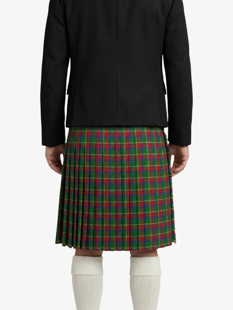 Person wearing a black jacket and green plaid kilt on a white background