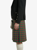 Person wearing a black blazer and red plaid kilt on a white background