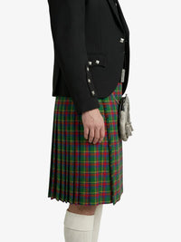 Person wearing a black jacket and green plaid kilt on a white background
