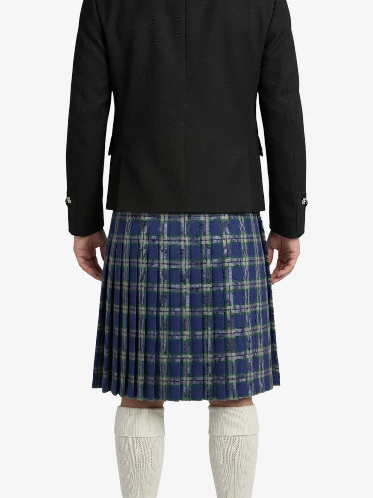 Person wearing a black jacket and blue plaid kilt on a white background