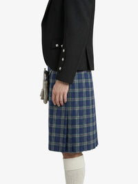 Person wearing a black jacket and blue plaid kilt on a white background
