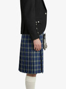 Person wearing a black jacket and blue plaid kilt on a white background