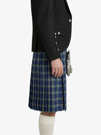 Person wearing a black jacket and blue plaid kilt on a white background
