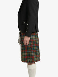 Person wearing a black jacket and plaid skirt on a white background