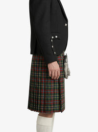 Person wearing a black jacket and plaid kilt on a white background