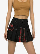 Black skirt with red plaid accents worn by a person on a white background