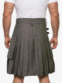 Person wearing a gray pleated kilt on a white background