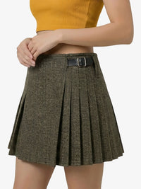 Person wearing a brown pleated skirt with a belt on a white background
