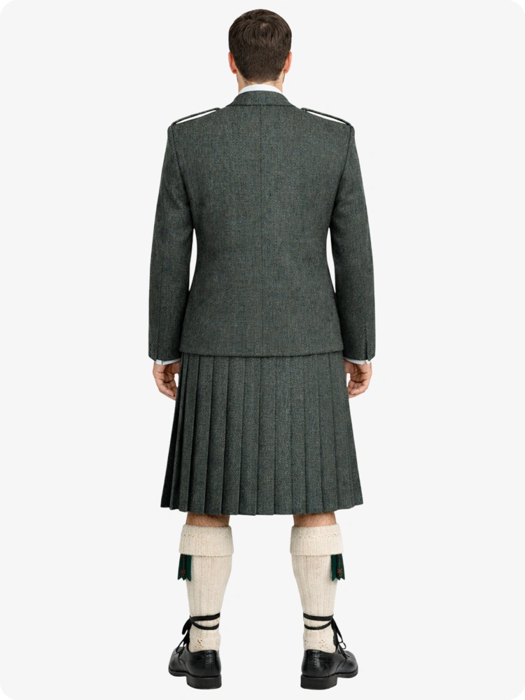 Person wearing a traditional Scottish kilt on a white background