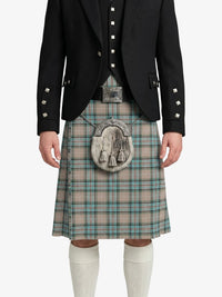 Person wearing a black jacket and plaid kilt on a white background