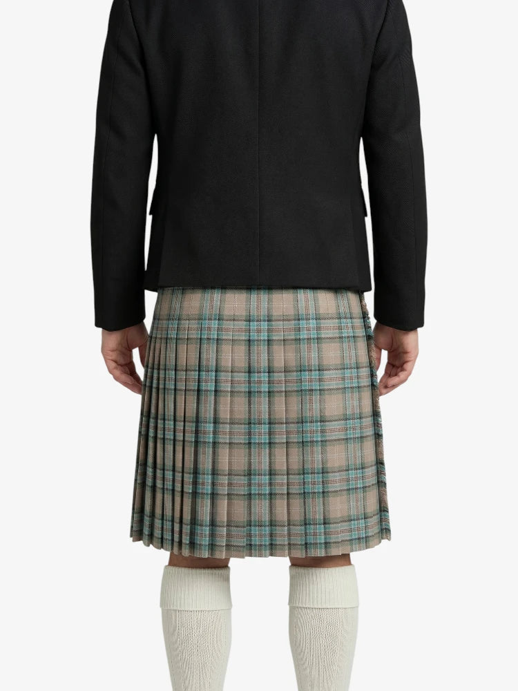 Person wearing a black jacket and plaid kilt on a white background