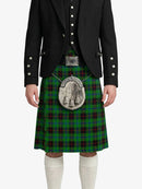 Person wearing a traditional Scottish kilt with a tartan pattern on a white background
