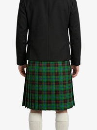Person wearing a black jacket and green plaid kilt on a white background