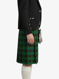 Person wearing a black jacket and green plaid kilt on a white background