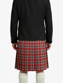 Person wearing a black jacket and red plaid kilt on a white background