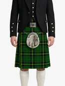 Person wearing a green tartan kilt with a black jacket on a white background
