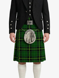 Person wearing a green tartan kilt with a black jacket on a white background