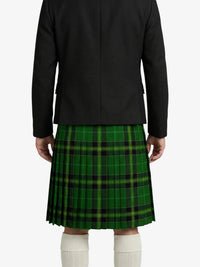 Person wearing a black jacket and green plaid kilt on a white background
