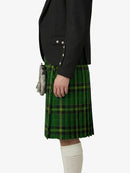 Person wearing a black jacket and green plaid kilt on a white background