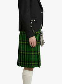 Person wearing a green plaid kilt with a black jacket on a white background
