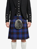 Person wearing a black jacket and blue plaid kilt on a white background