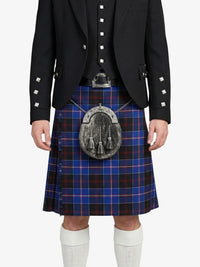 Person wearing a black jacket and blue plaid kilt on a white background