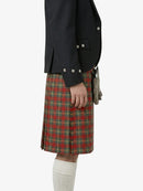 Person wearing a dark jacket and red plaid kilt on a white background