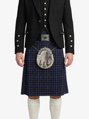 Person wearing a traditional Scottish kilt with a jacket on a white background