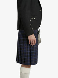 Person wearing a dark jacket and blue plaid kilt on a white background