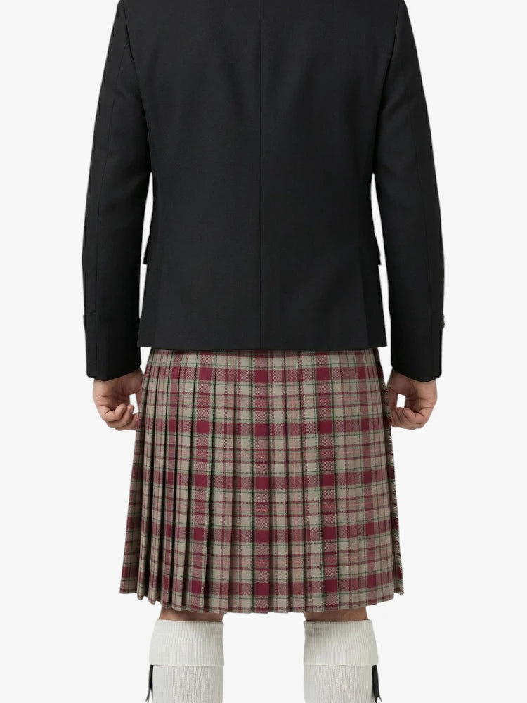 Person wearing a black jacket and plaid kilt on a white background