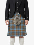 Person wearing a traditional Scottish kilt with a jacket and white socks on a white background