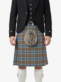 Person wearing a traditional Scottish kilt with a jacket and white socks on a white background