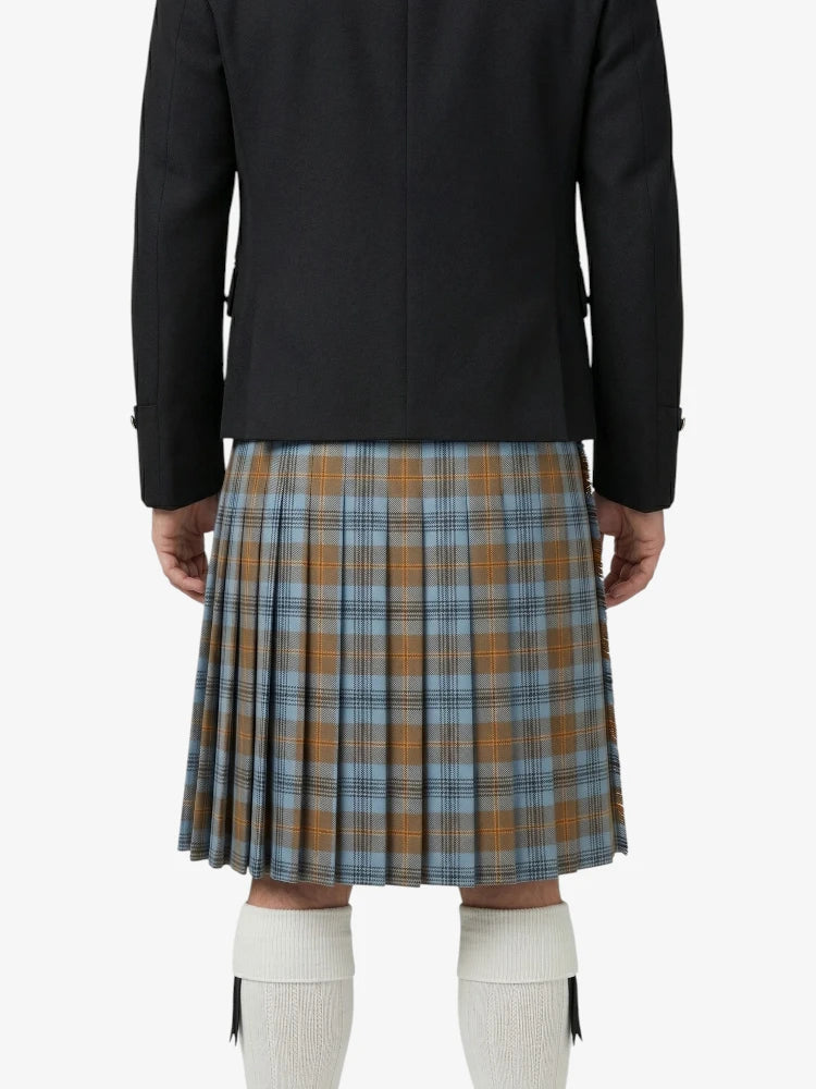 Person wearing a black jacket and plaid kilt on a white background