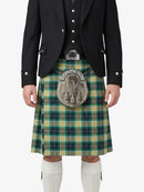 Person wearing a traditional Scottish kilt with a tartan pattern on a white background