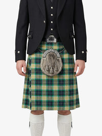 Person wearing a traditional Scottish kilt with a tartan pattern on a white background