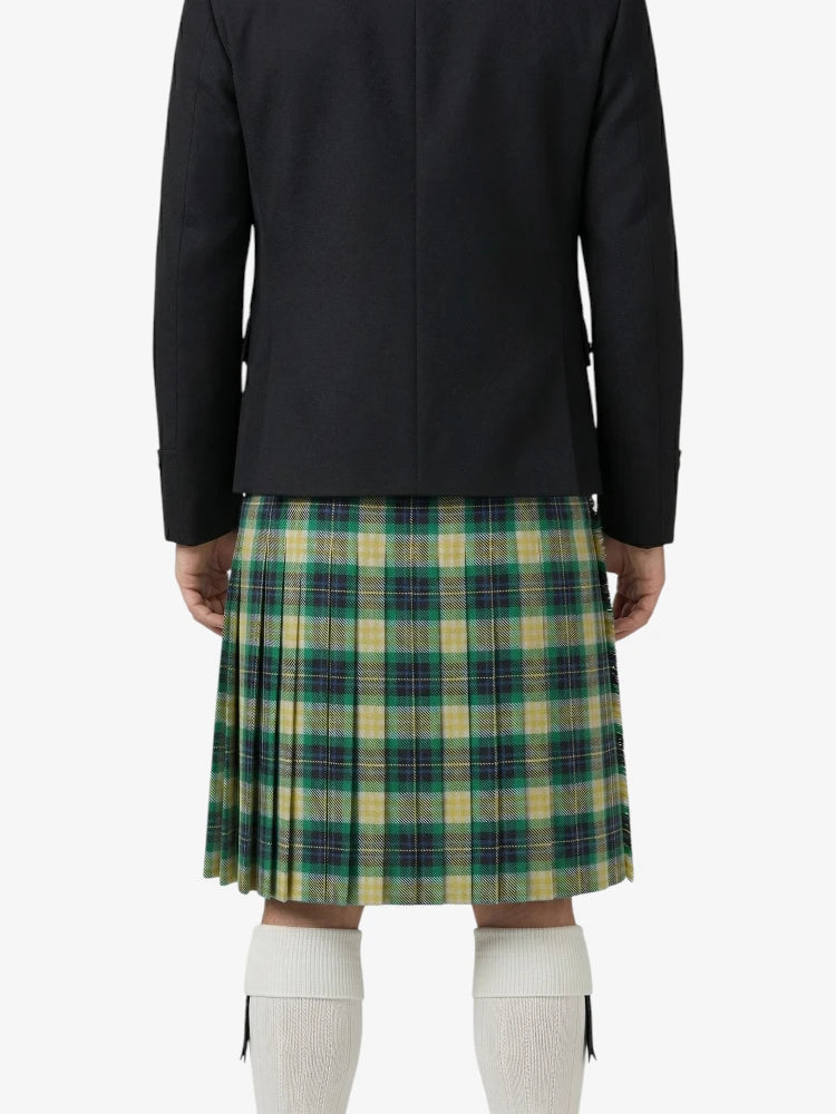 Person wearing a black jacket and green plaid kilt on a white background