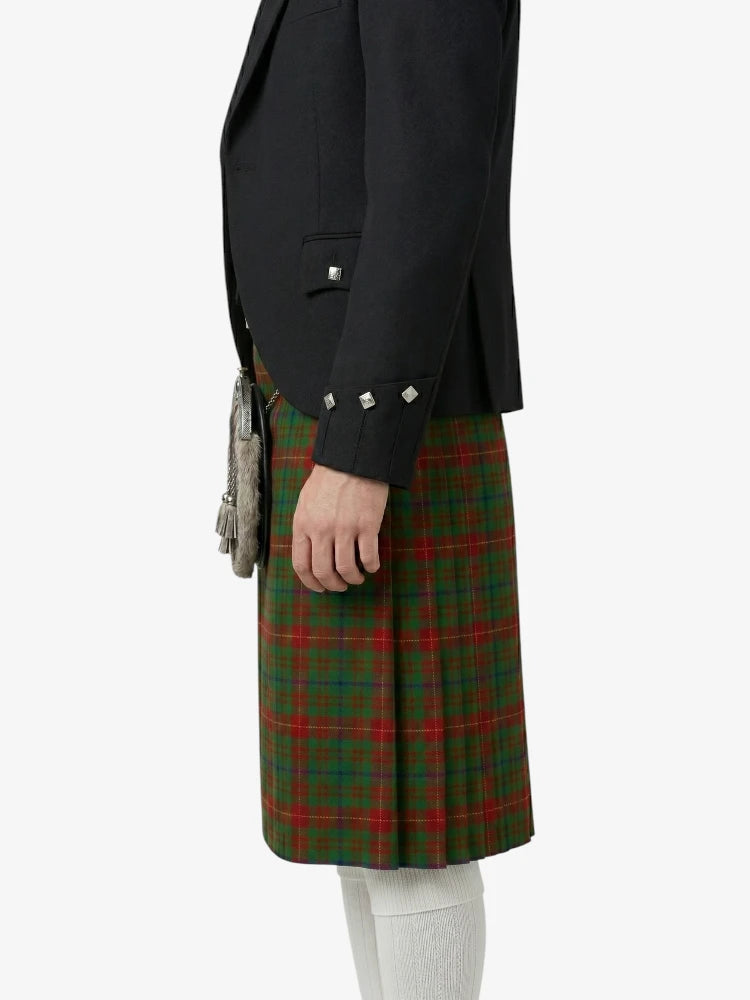Person wearing a black jacket and green plaid skirt on a white background