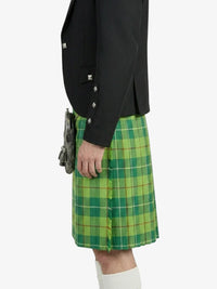 Person wearing a green plaid kilt with a black jacket on a white background