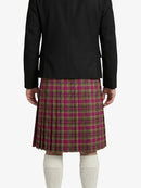 Person wearing a black jacket and plaid kilt on a white background
