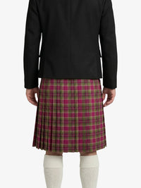 Person wearing a black jacket and plaid kilt on a white background