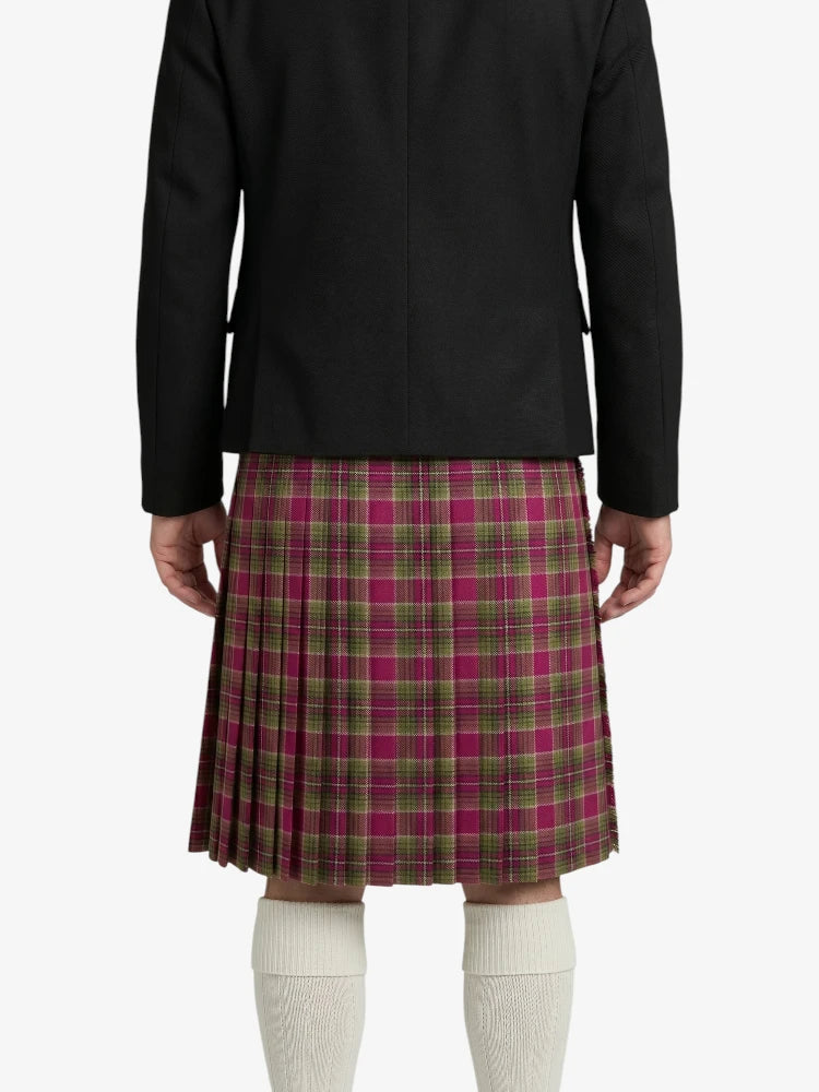 Person wearing a black jacket and plaid kilt on a white background