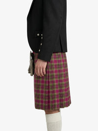 Person wearing a black jacket and a plaid kilt on a white background