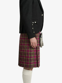 Person wearing a black blazer and plaid kilt on a white background