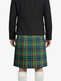Person wearing a black jacket and plaid kilt on a white background